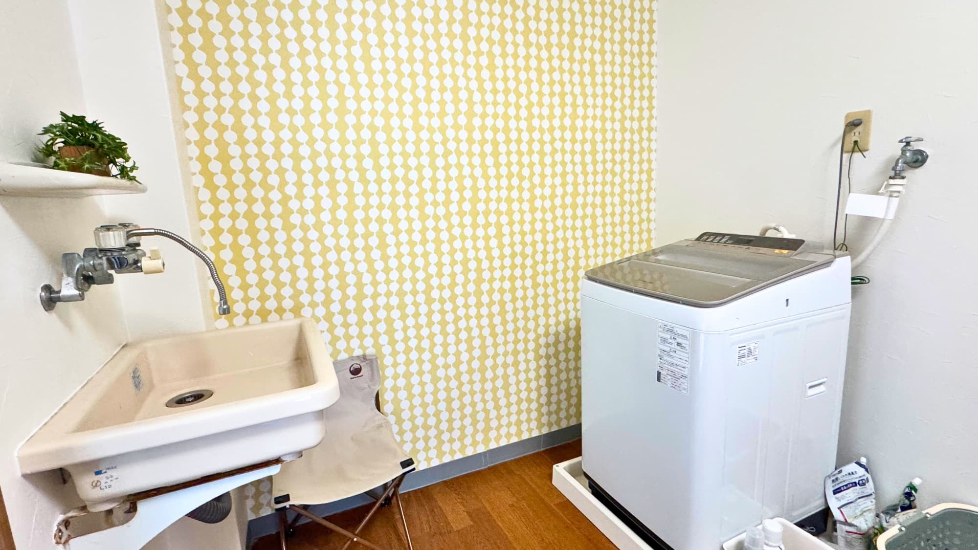 Laundry area with washing machine and sink