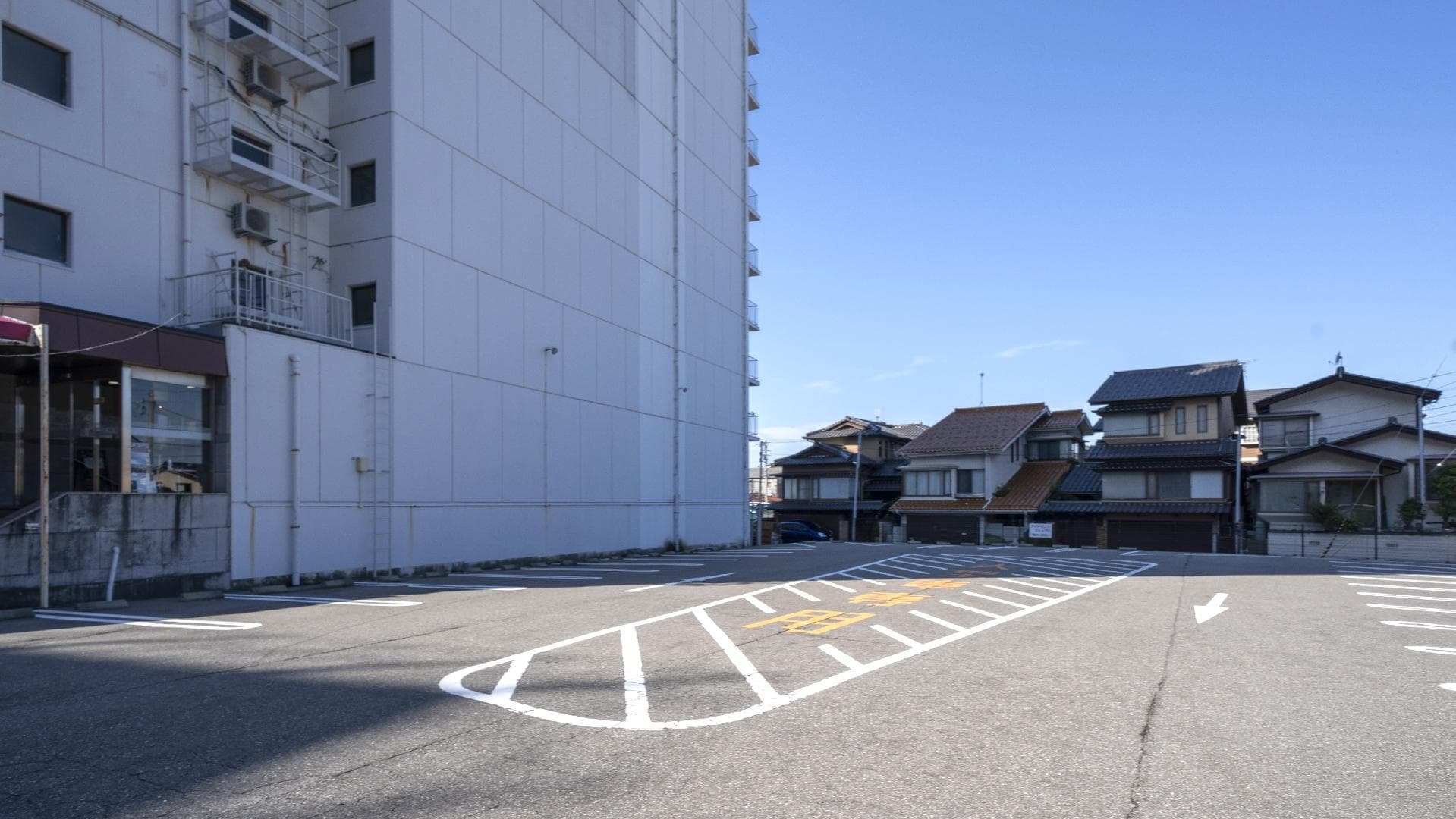 [Hotel parking lot]