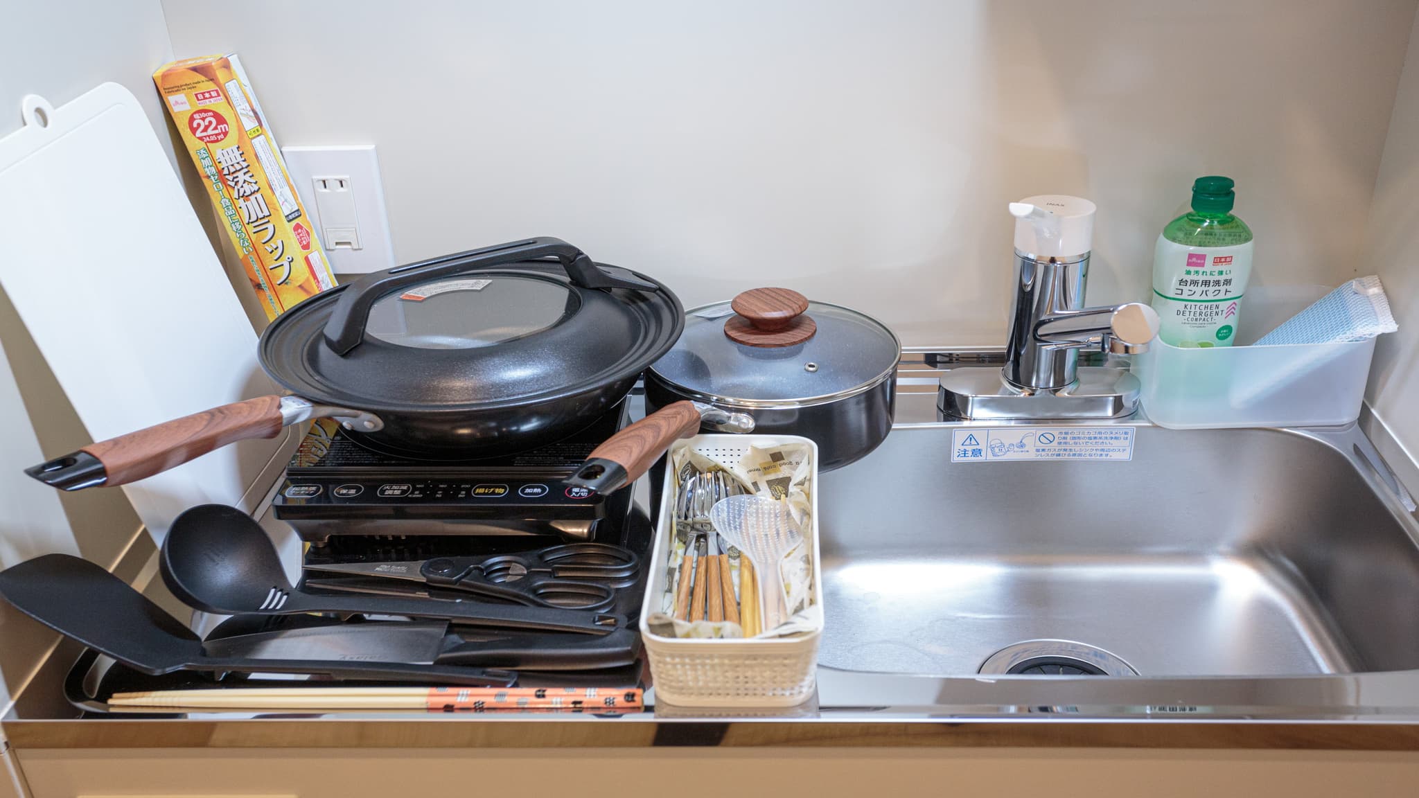 Frying pans, pots, cooking utensils and tableware are provided.