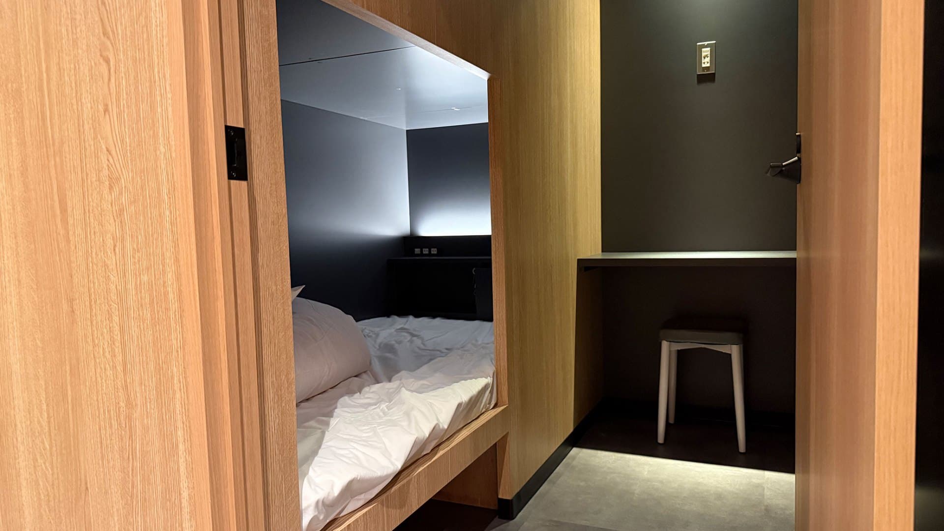 Semi-private room with a small desk and chair