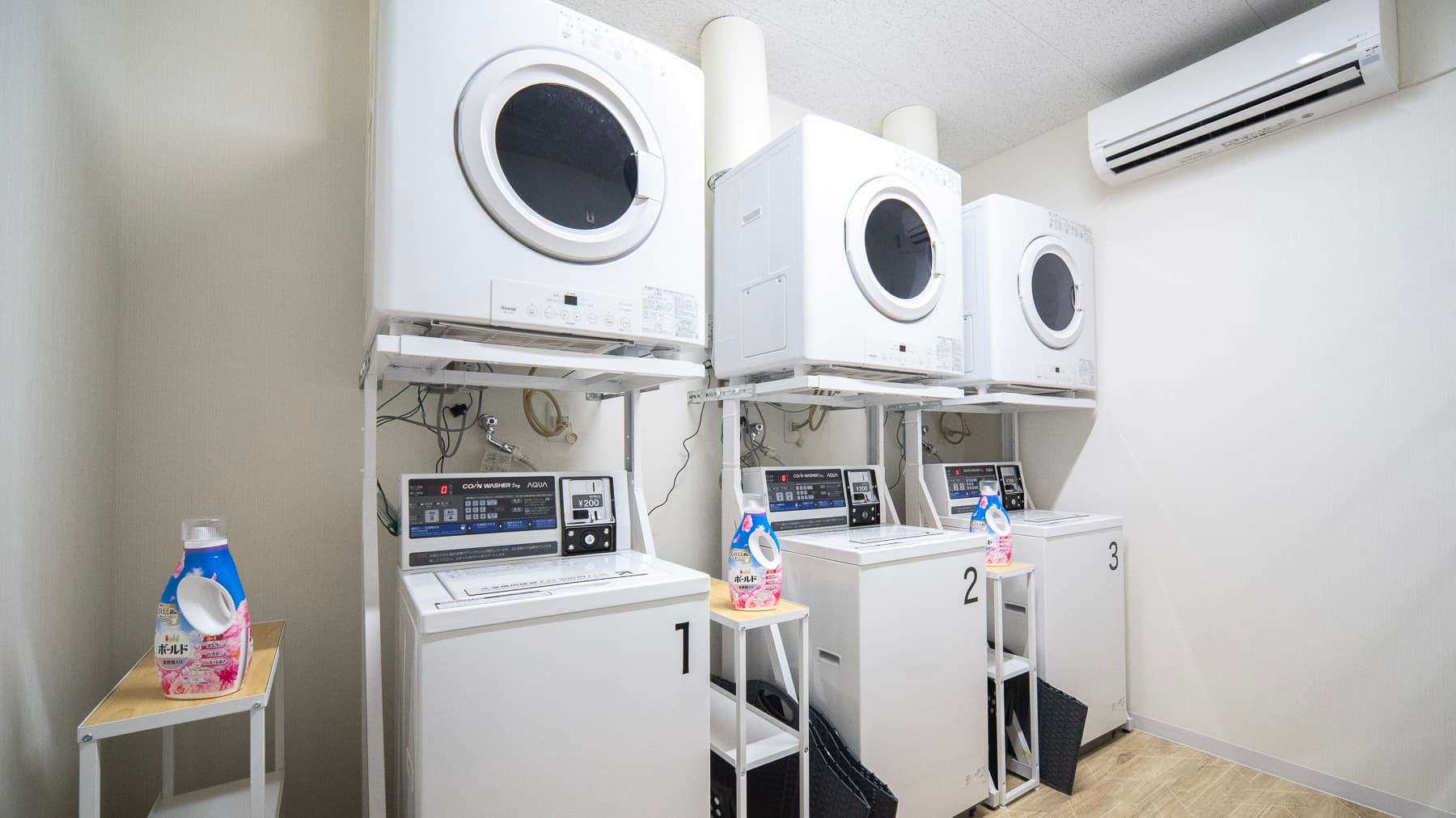 There are three washing machines and three dryers available.