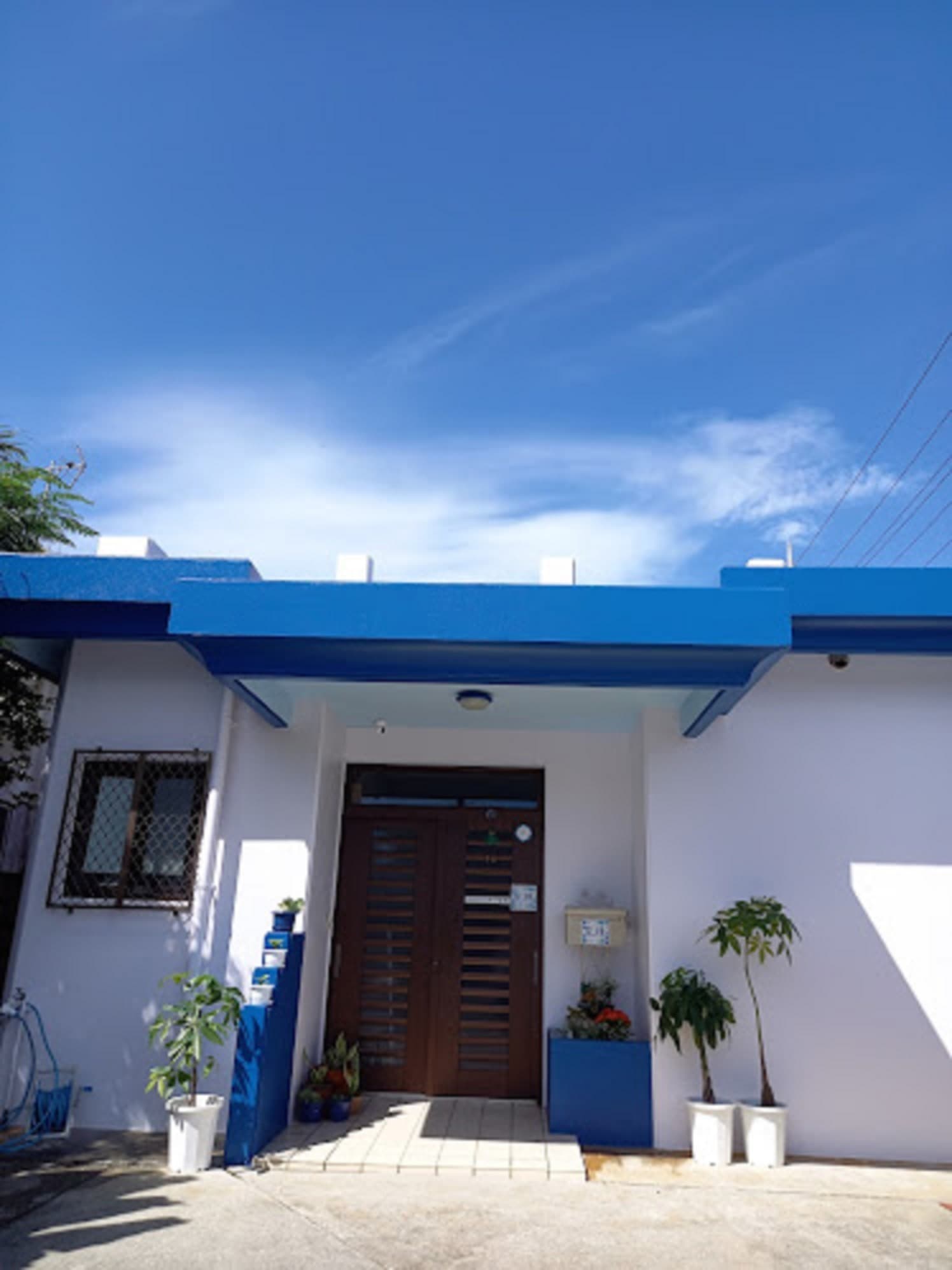 It is a blue building on white. We have two parking spaces available.