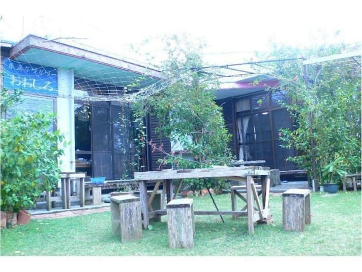 A Garden with Wooden Tables, and Barbecue