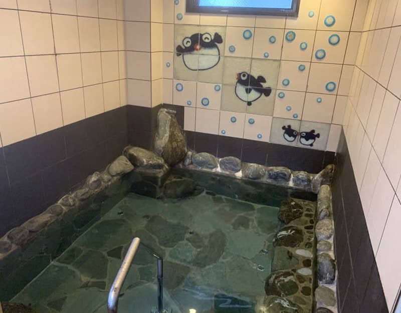 Two baths watched over by fugu