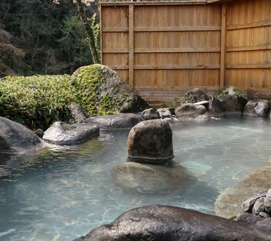An Open-Air Bath Facing a Waterfall
