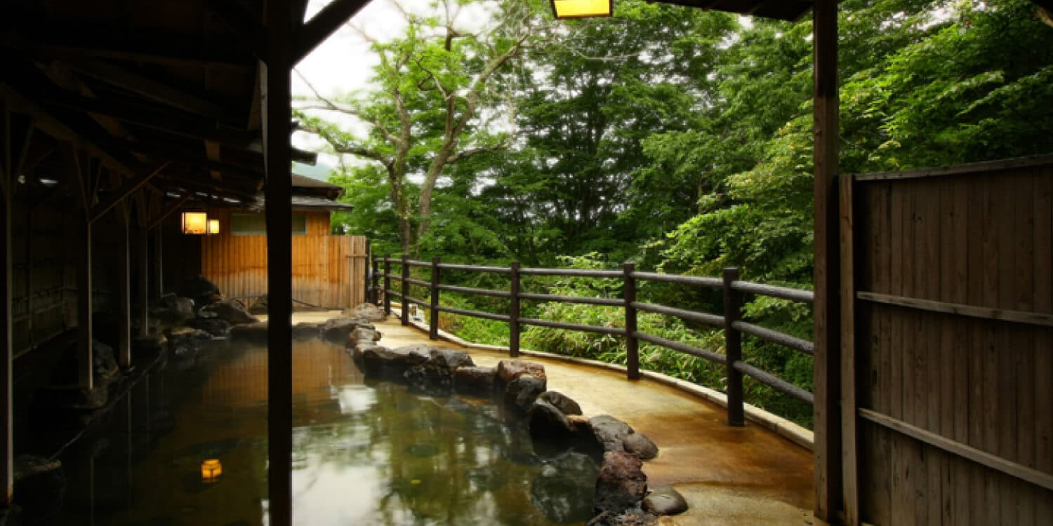 Open-air baths over river and hills