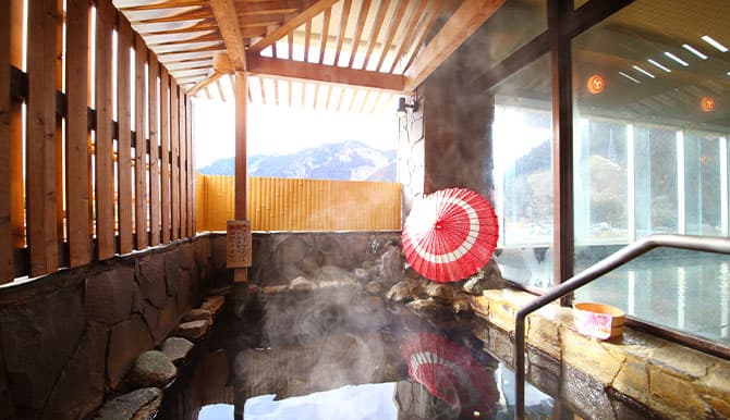 The open-air bath and its mountain village view